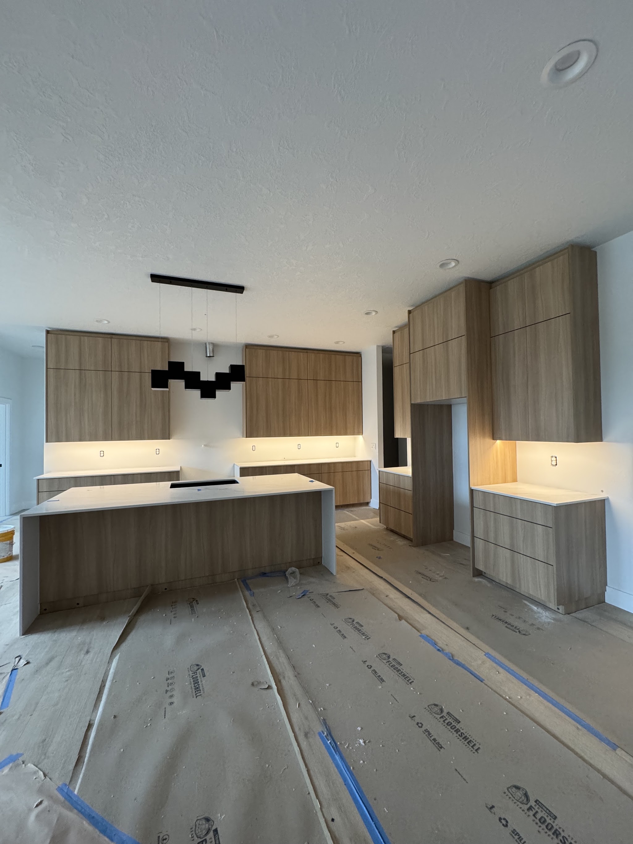 Modern finished kitchen with a large island and pendant lighting