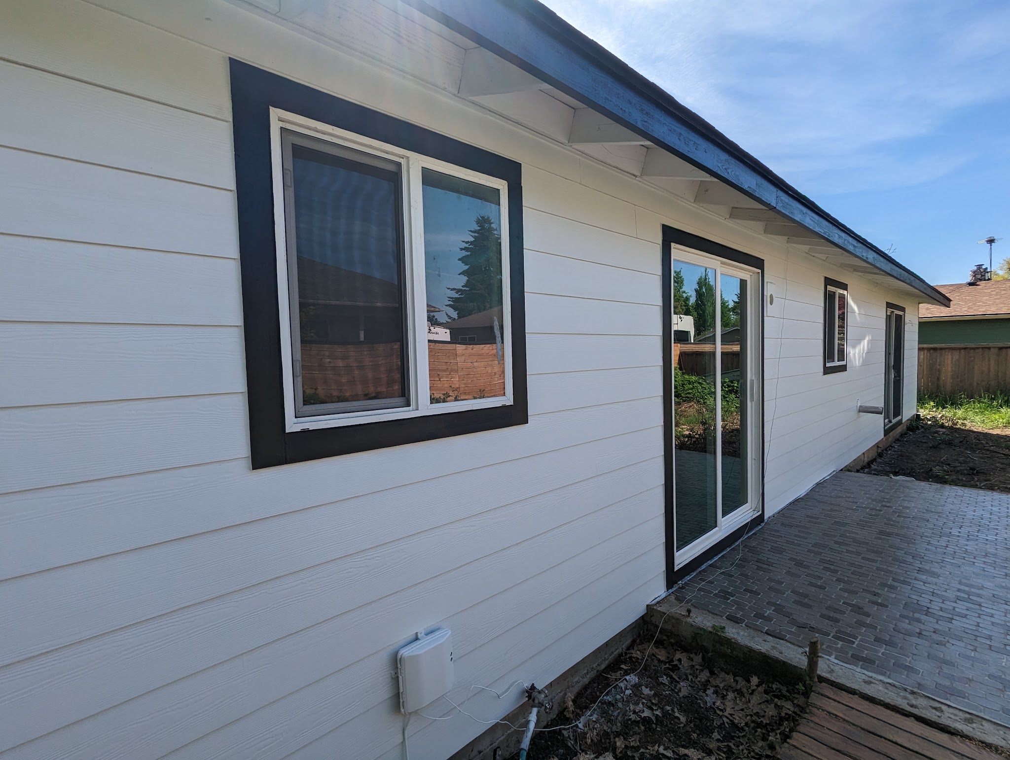 Finished exterior siding and dark window trim